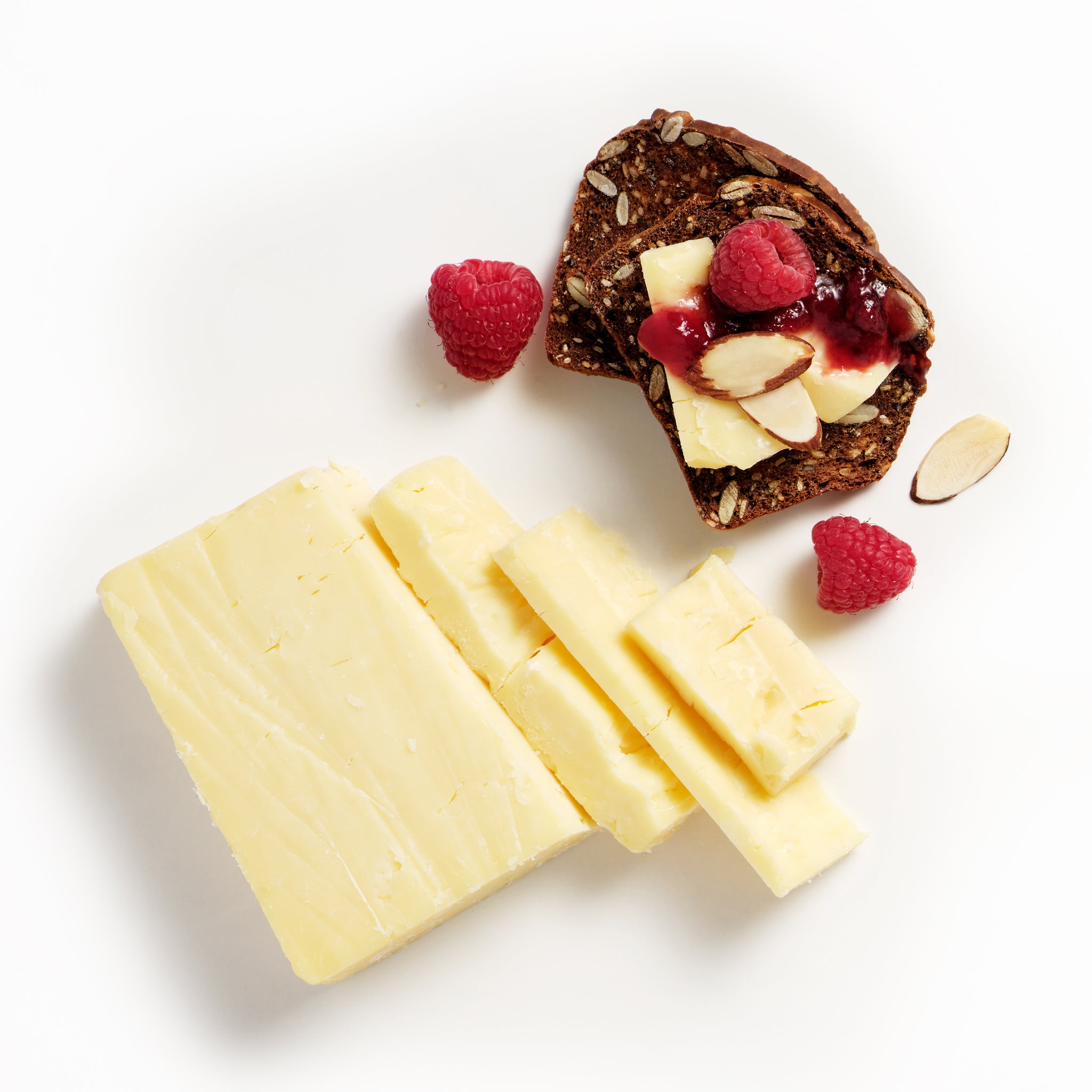 Cathedral City Vintage Cheddar Cheese on a Raincoast cracker with fresh raspberries and slivered almonds. 