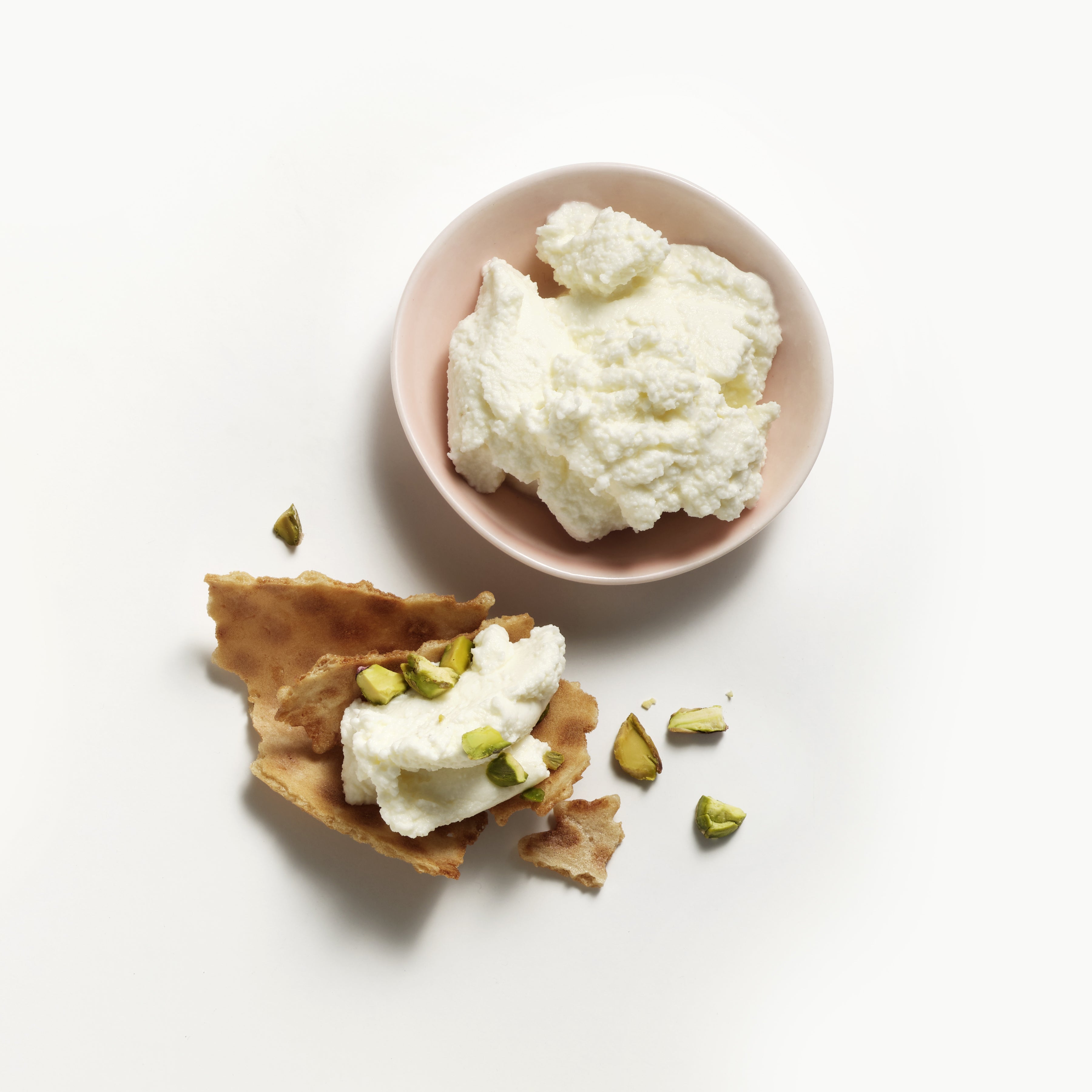Saputo Ricotta Fiorella with crumbled crushed pistachios on a sweet cracker
